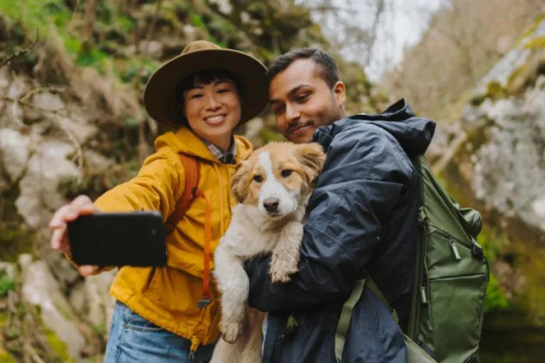 Smiling on a scenic mountain trail, a couple snaps a selfie with their dog. Supported by the peace of mind and protection of their Civic Signature Checking account, they are free to focus entirely on the moments that matter most.