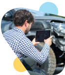 Man taking a photo of the damage to is car after a wreck for Insurance. 