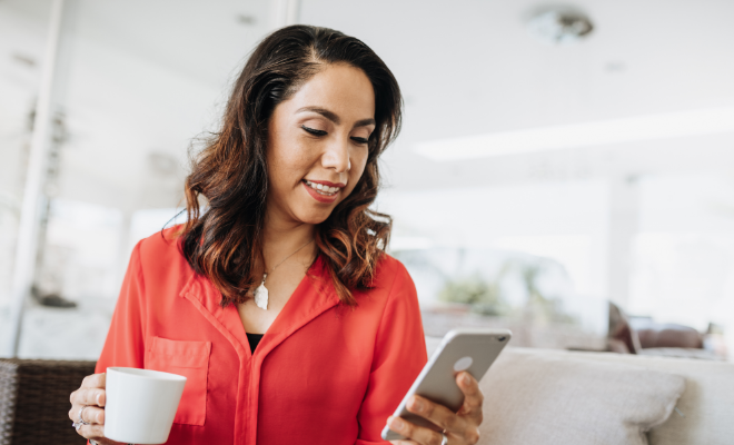 Woman checking her Money Market dividends on the Civic Credit Union mobile app.