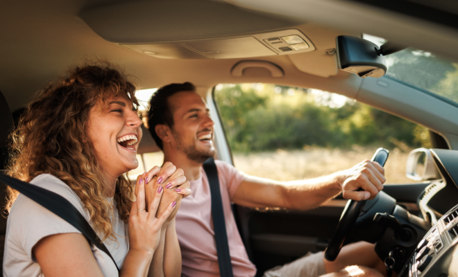 A happy couple enjoying their road trip in their new car, all thanks to Civic's auto loan and GAP coverage.
